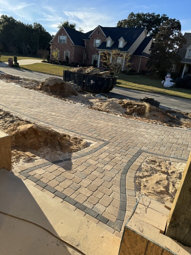 a brick walkway being built in front of a house